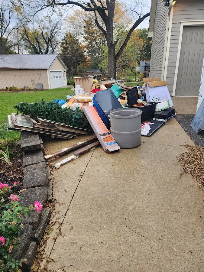Dumpster being loaded with debris for Roofing Dumpster Rental in Columbus